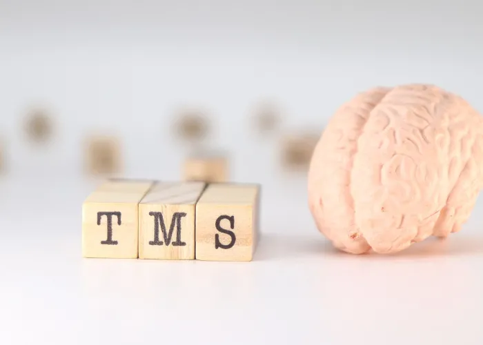 TMS Acronym Transcranial magnetic stimulation concept with brain on white background