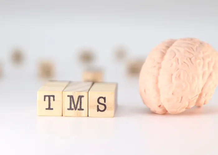 TMS Acronym Transcranial magnetic stimulation concept with brain on white background