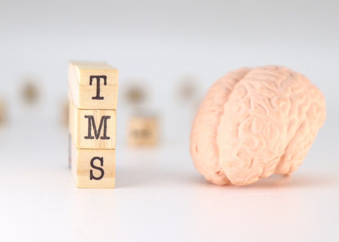 TMS Acronym Transcranial magnetic stimulation concept with brain on white background