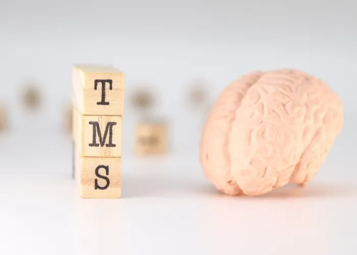 TMS Acronym Transcranial magnetic stimulation concept with brain on white background